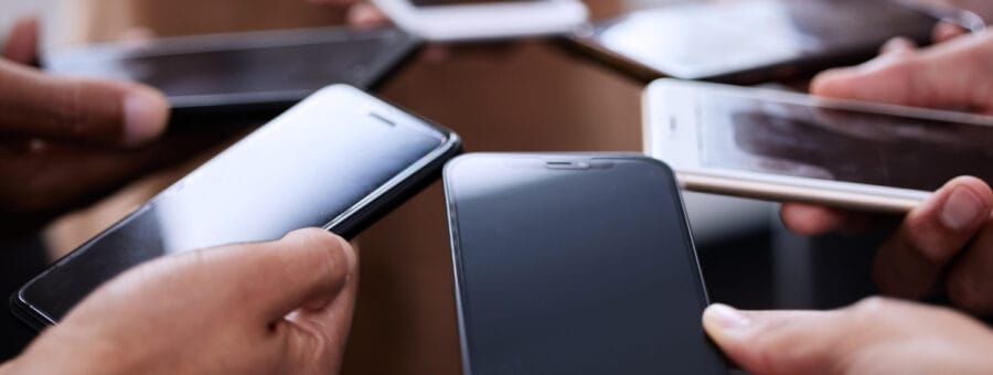 People, hands and smartphones together in circle for contact, connection and communication. Social media, team and group of mobile in closeup for networking, collaboration and employee synergy